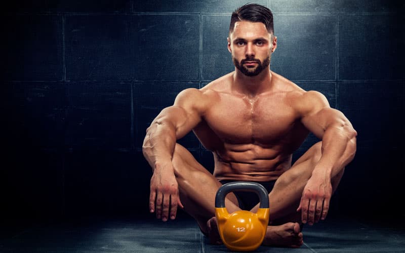 A man mid-life training with a kettlebell — the returning strength that shows up on TRT over months, not days